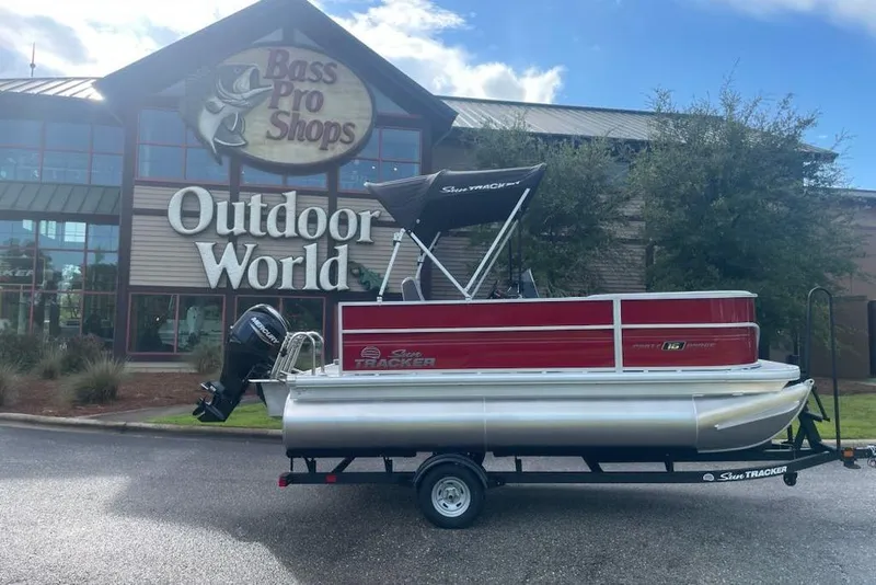 Slide: The Image of 2026 Sun Tracker Party Barge 16 DLX pontoon boat outside Bass Pro Shops. - 4