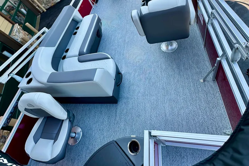 Slide: The Image of 2026 Sun Tracker Bass Buggy 18 DLX interior with gray seating and cup holders. - 16