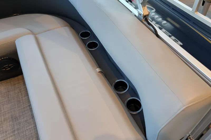 Slide: The Image of 2026 Sun Tracker Party Barge 16 DLX interior seating with cup holders. - 45