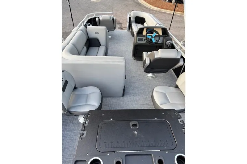 Slide: The Image of 2026 Sun Tracker SportFish 20 DLX pontoon boat interior with seating and steering console. - 2