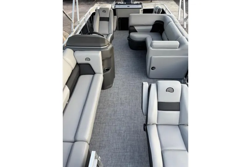 Slide: The Image of 2026 Sun Tracker SportFish 20 DLX pontoon boat interior with gray seating and spacious layout. - 3