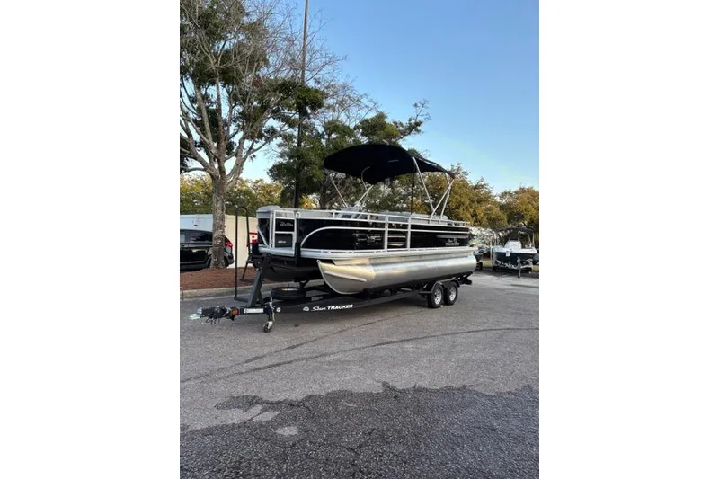 Slide: The Image of 2026 Sun Tracker SportFish 20 DLX pontoon boat on trailer, parked outdoors. - 4