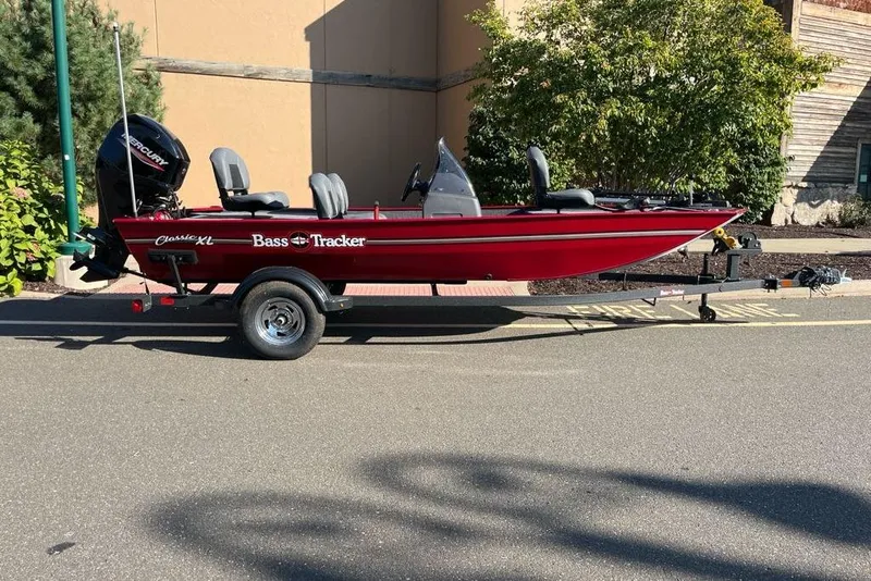 The Image of 2026 Tracker Bass Tracker Classic XL boat on trailer, parked outdoors. - 0