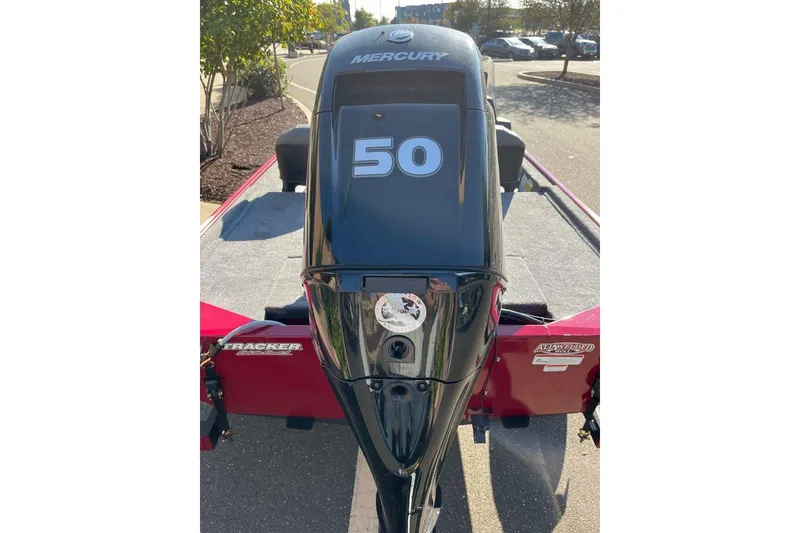 Slide: The Image of 2026 Tracker Bass Tracker Classic XL with Mercury 50 HP engine, parked outdoors. - 2
