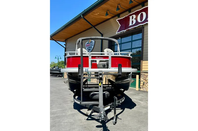 Slide: The Image of 2026 Sun Tracker Bass Buggy 16 XL Select pontoon boat displayed outdoors. - 73