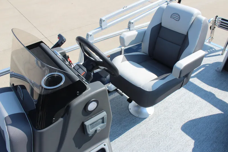 Slide: The Image of 2026 Sun Tracker Bass Buggy 18 DLX boat interior with steering console and captain's chair. - 11