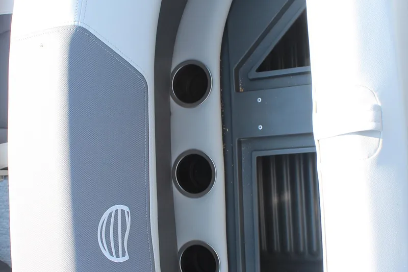 Slide: The Image of 2026 Sun Tracker Bass Buggy 18 DLX interior detail with cup holders and storage compartment. - 15