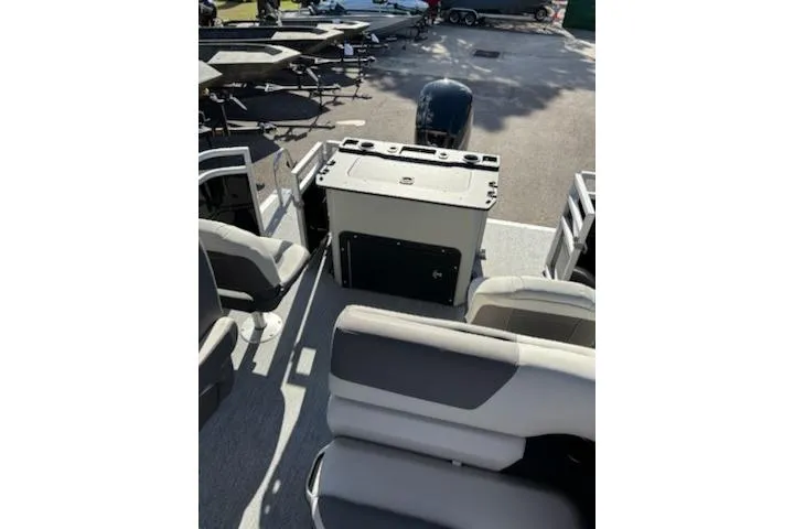 Slide: The Image of 2026 Sun Tracker Fishin' Barge 20 DLX interior with seating and console. - 2
