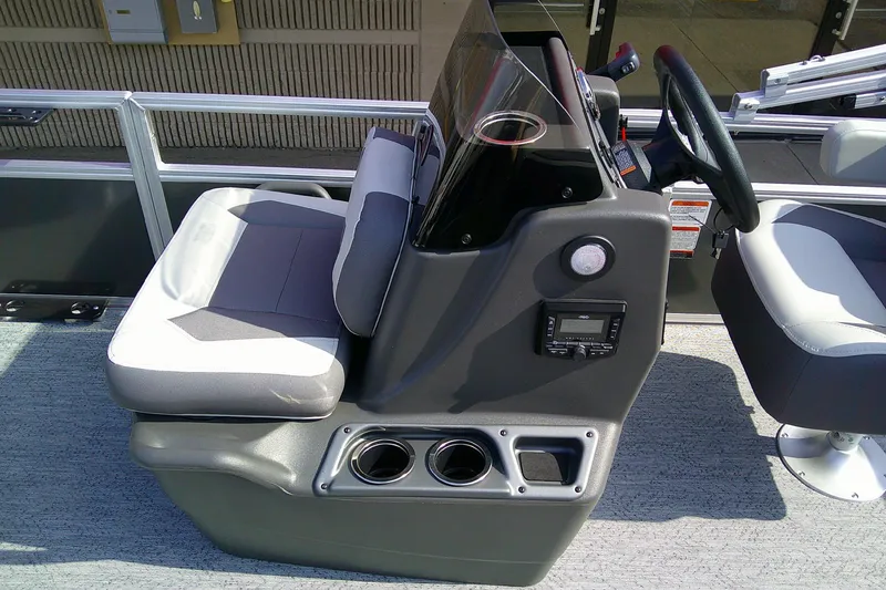 Slide: The Image of 2026 Sun Tracker Bass Buggy 16 XL Select boat interior with steering console and seating. - 13