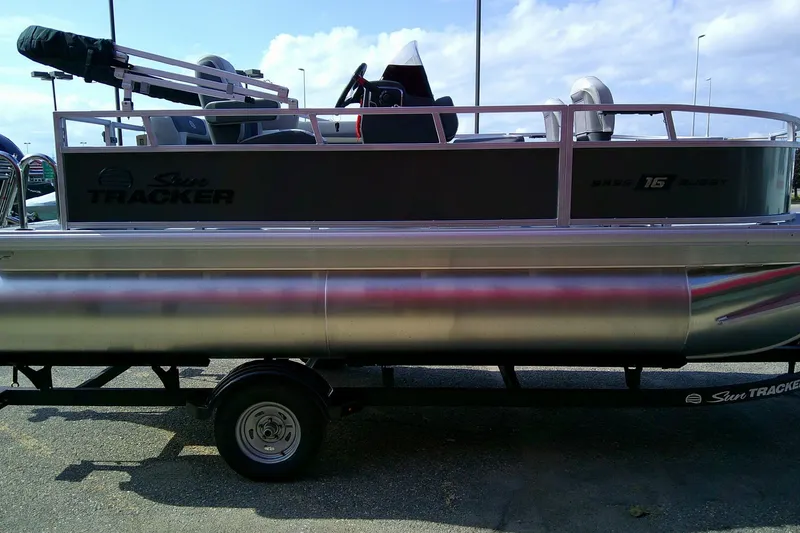 Slide: The Image of 2026 Sun Tracker Bass Buggy 16 XL Select pontoon boat on trailer, side view. - 4