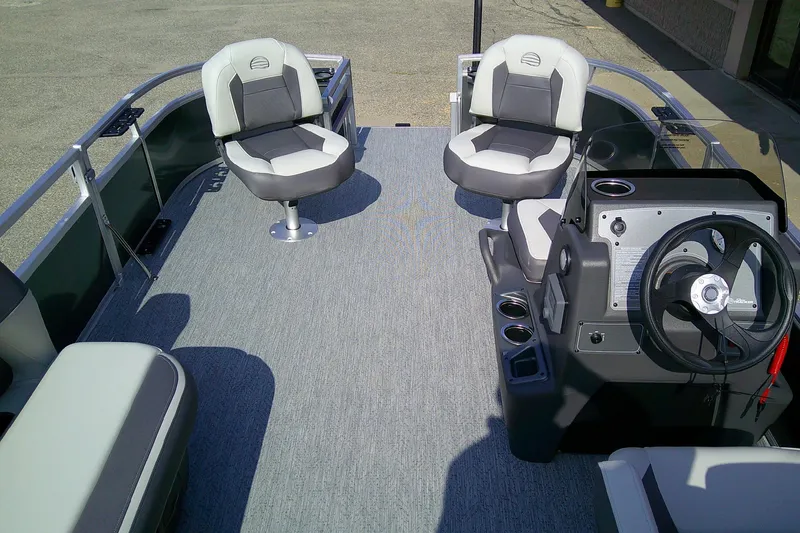 Slide: The Image of 2026 Sun Tracker Bass Buggy 16 XL Select pontoon boat interior with seating and steering console. - 7