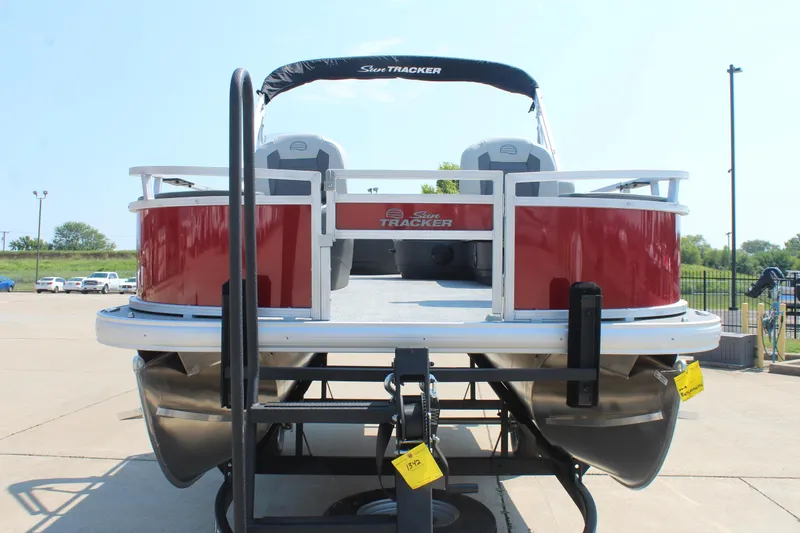 Slide: The Image of 2026 Sun Tracker Bass Buggy 18 DLX pontoon boat with outboard motor, rear view. - 2