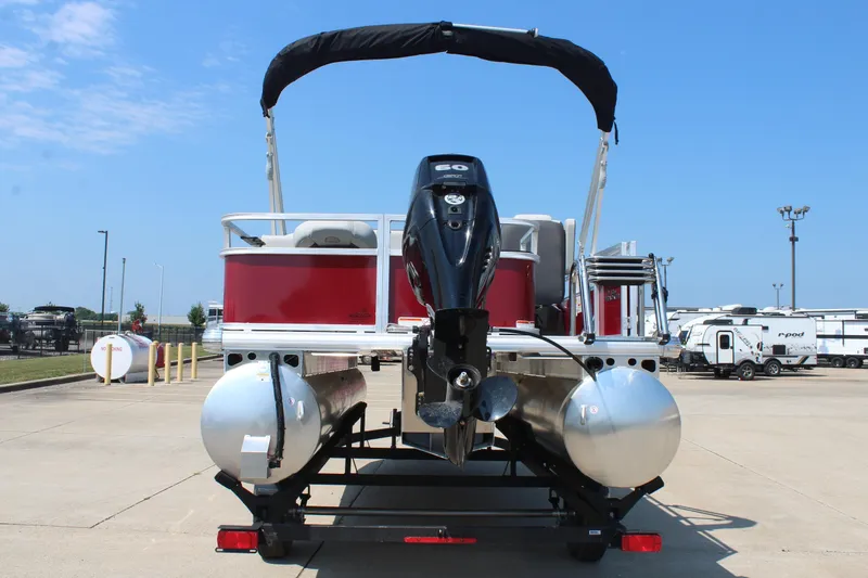 Slide: The Image of 2026 Sun Tracker Bass Buggy 18 DLX pontoon boat with red exterior on a trailer. - 6