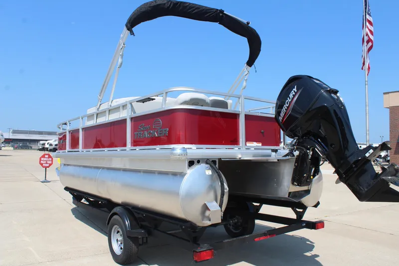 Slide: The Image of 2026 Sun Tracker Bass Buggy 18 DLX pontoon boat displayed at dealership. - 7