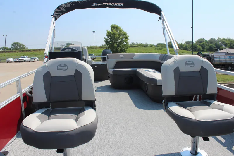 Slide: The Image of 2026 Sun Tracker Bass Buggy 18 DLX pontoon boat interior with seating and canopy. - 8