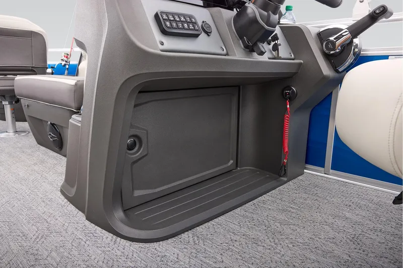 Slide: The Image of 2026 Sun Tracker Fishin' Barge 20 DLX interior storage compartment with gray carpet flooring. - 47