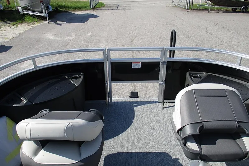 Slide: The Image of 2026 Sun Tracker Fishin' Barge 20 DLX interior with seating and storage compartments. - 11