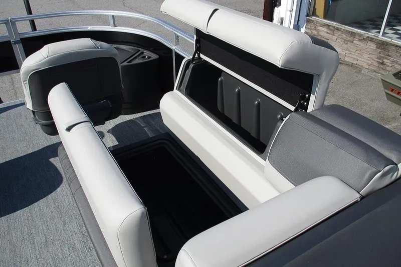 Slide: The Image of 2026 Sun Tracker Fishin' Barge 20 DLX interior seating with storage compartments open. - 17