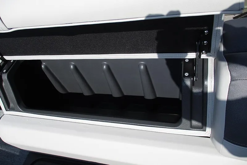 Slide: The Image of 2026 Sun Tracker Fishin' Barge 20 DLX storage compartment, open and empty. - 19