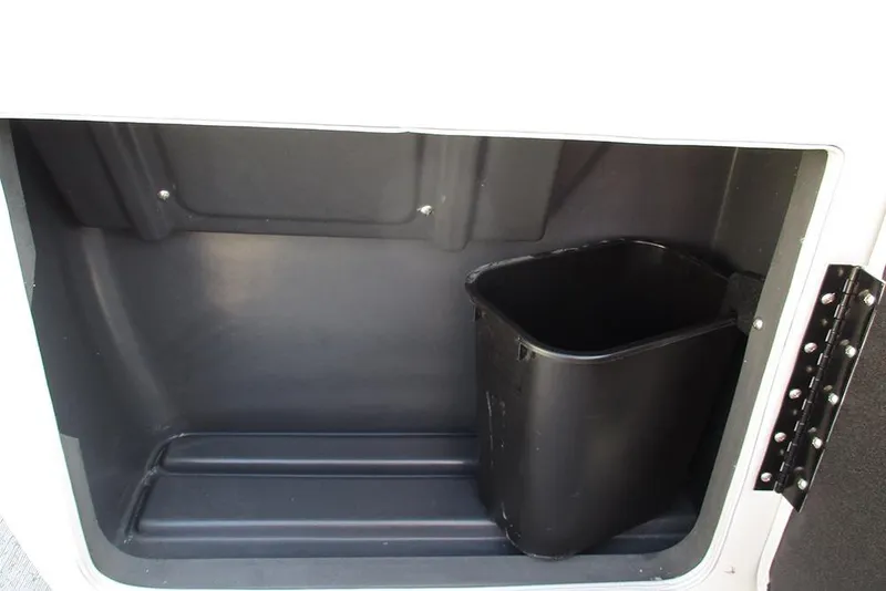 Slide: The Image of Storage compartment with black bin in 2026 Sun Tracker Fishin' Barge 20 DLX. - 24