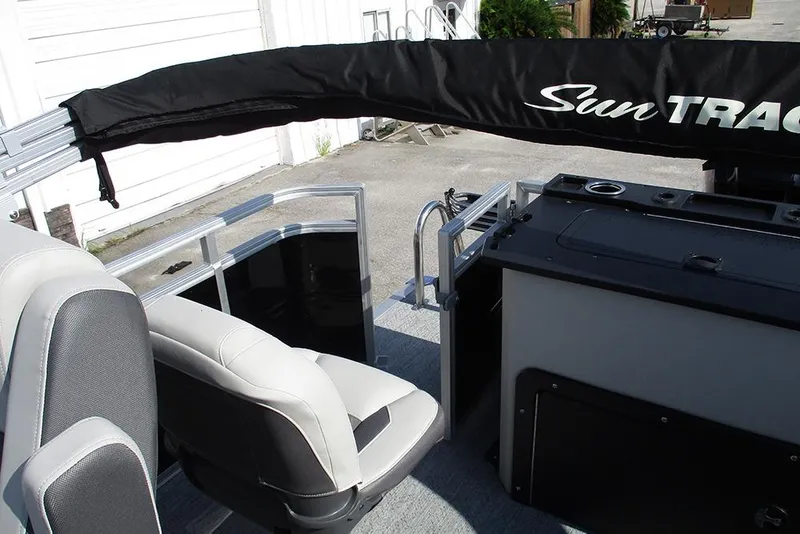 Slide: The Image of 2026 Sun Tracker Fishin' Barge 20 DLX interior with seating and storage compartments. - 29