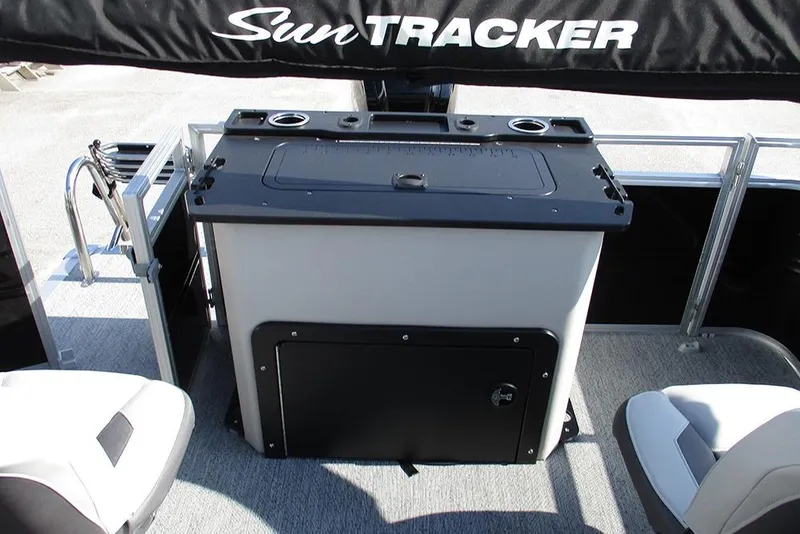 Slide: The Image of 2026 Sun Tracker Fishin' Barge 20 DLX interior with seating and storage area. - 30