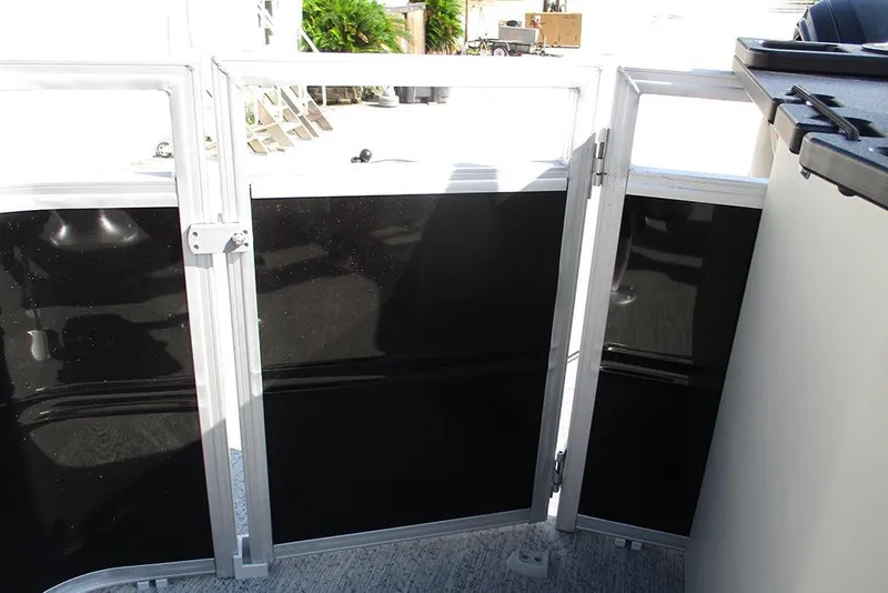 Slide: The Image of 2026 Sun Tracker Fishin' Barge 20 DLX gate detail with black paneling. - 32