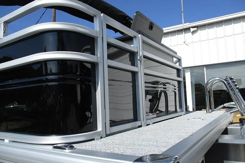 Slide: The Image of 2026 Sun Tracker Fishin' Barge 20 DLX pontoon boat, sleek design, docked outdoors. - 36