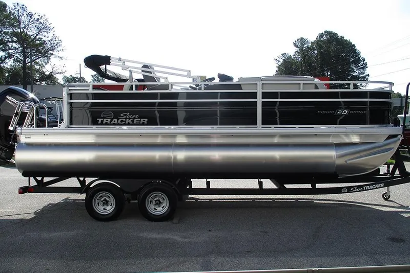 Slide: The Image of 2026 Sun Tracker Fishin' Barge 20 DLX pontoon boat on trailer, side view. - 6