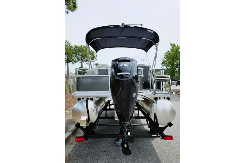 Slide: The Image of 2026 Sun Tracker Bass Buggy 18 DLX pontoon boat with Mercury 75 engine, rear view. - 3