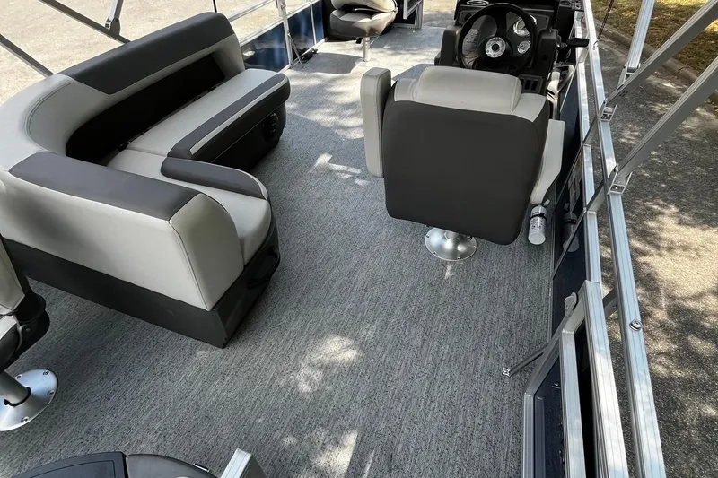 Slide: The Image of 2026 Sun Tracker Bass Buggy 18 DLX interior with seating and steering console. - 6