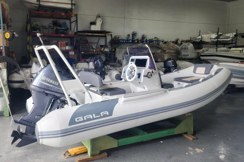 Slide: The Image of 2026 Gala A450L inflatable boat with Yamaha engine in a workshop setting. - 5