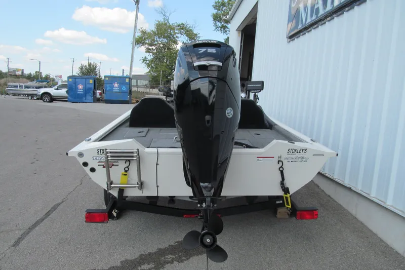 Slide: The Image of 2023 Tracker Pro Team 175 TXW Tournament Edition boat, rear view with motor, parked outdoors. - 4