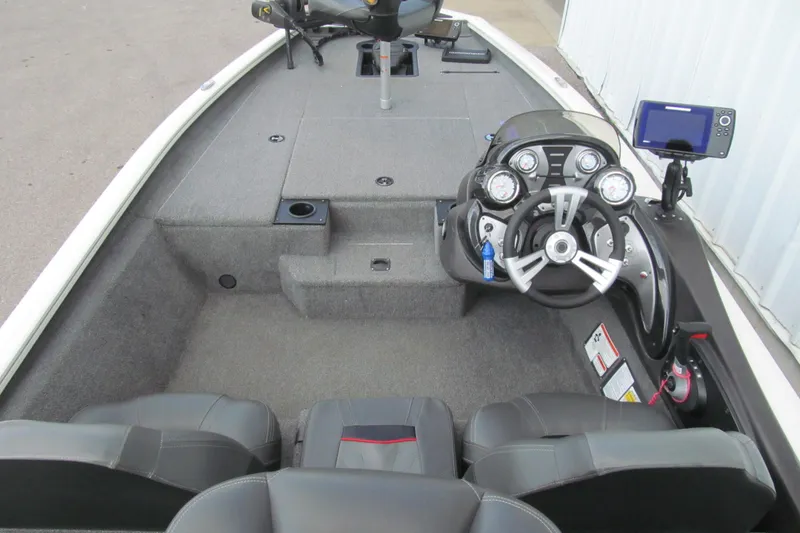 Slide: The Image of 2023 Tracker Pro Team 175 TXW Tournament Edition boat interior with steering console and seating. - 5