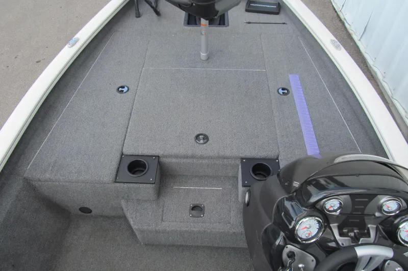 Slide: The Image of 2023 Tracker Pro Team 175 TXW Tournament Edition boat interior with carpeted deck and control panel. - 7