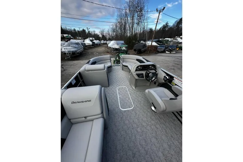 Slide: The Image of 2025 Berkshire 22CL2 LE pontoon boat interior with gray seating and steering console. - 3