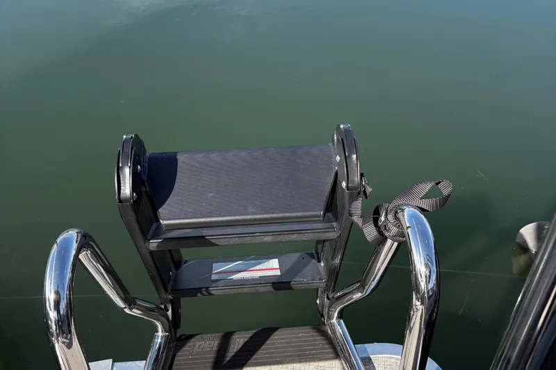 Slide: The Image of Stainless steel ladder on 2025 Harris Cruiser 230 pontoon boat over calm water. - 10