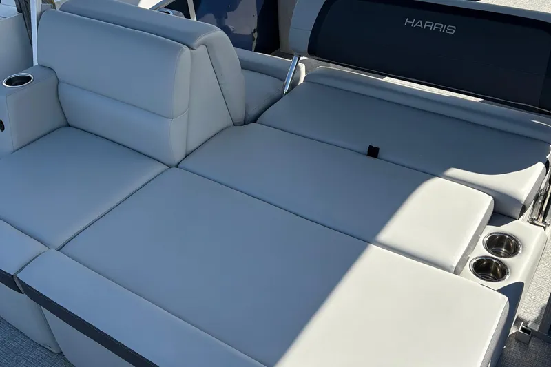 Slide: The Image of Luxurious seating on 2025 Harris Cruiser 230 boat with cup holders and sleek design. - 12