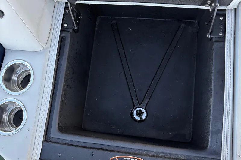 Slide: The Image of Storage compartment and cup holders on a 2025 Harris Cruiser 230 boat. - 13