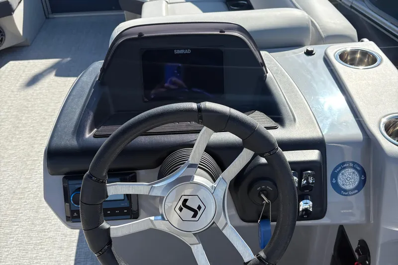 Slide: The Image of Steering console of 2025 Harris Cruiser 230 boat with modern controls and display. - 6