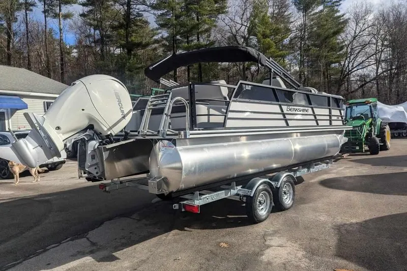 Slide: The Image of 2025 Berkshire 22UL LE pontoon boat on trailer, parked outdoors. - 4