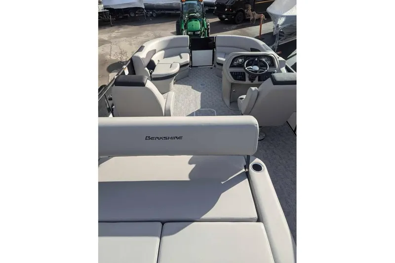 Slide: The Image of 2025 Berkshire 22UL LE pontoon boat interior with plush seating and modern helm. - 9