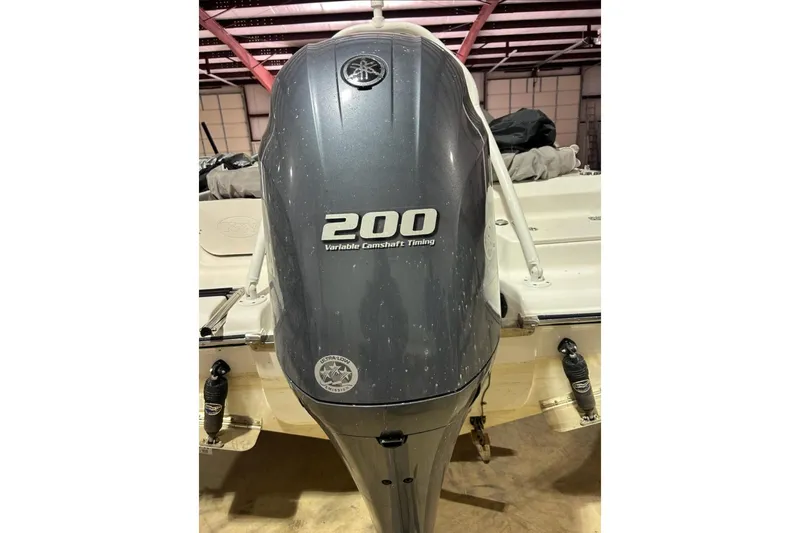 Slide: The Image of 2023 Key West 203 DFS boat with 200 HP outboard motor in a garage. - 15