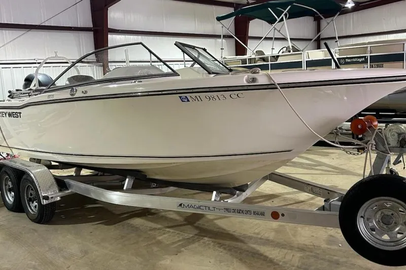 Slide: The Image of 2023 Key West 203 DFS boat on trailer in indoor storage facility. - 16