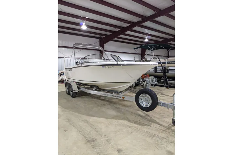 Slide: The Image of 2023 Key West 203 DFS boat on trailer in indoor storage facility. - 18