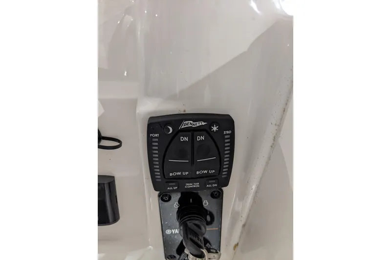 Slide: The Image of 2023 Key West 203 DFS boat control panel with trim tab switches. - 23