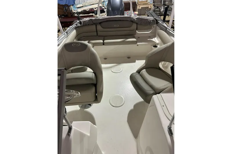 Slide: The Image of 2023 Key West 203 DFS boat interior with cushioned seating and steering wheel. - 6