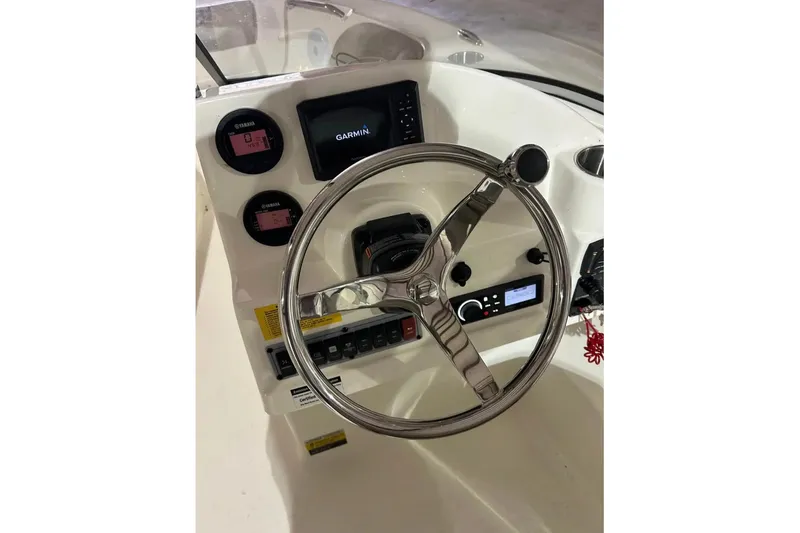 Slide: The Image of 2023 Key West 203 DFS boat dashboard with Garmin display and steering wheel. - 8