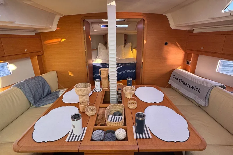 Slide: The Image of Interior of 2023 Dufour 37 yacht with cozy dining area and elegant decor. - 11