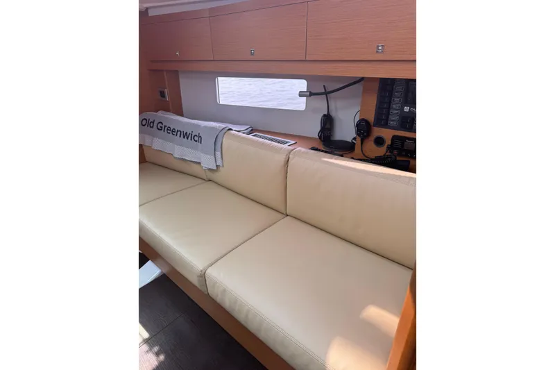 Slide: The Image of Interior of 2023 Dufour 37 yacht with beige seating and navigation equipment. - 14